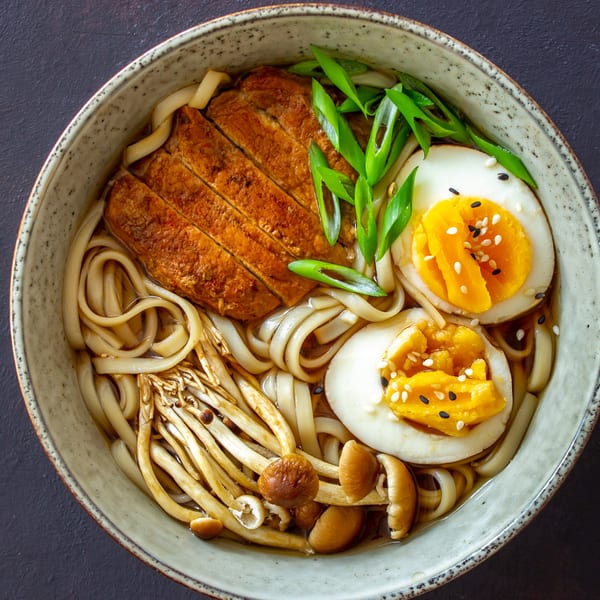 Kami Sushi & Asian Kitchen's ramen bowl with sliced chicken, noodles, mushrooms, green onions, and two soft-boiled eggs.